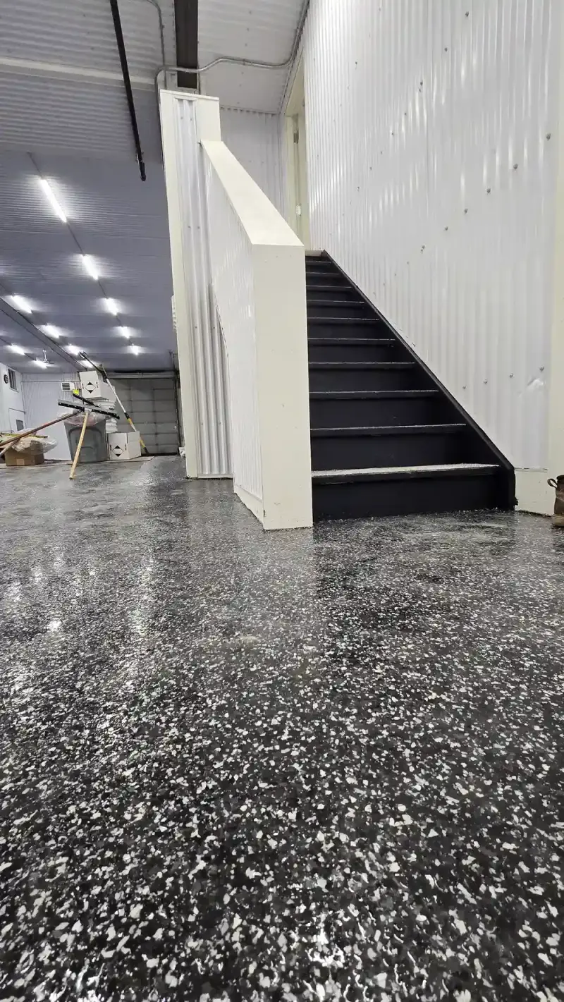 Epoxy-coated stairs leading to a finished basement