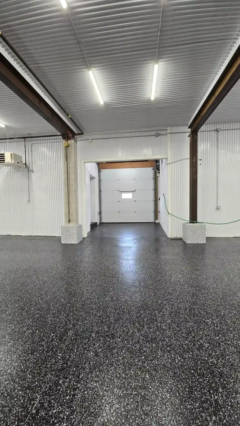 Black flake epoxy floor at a commercial shop entrance