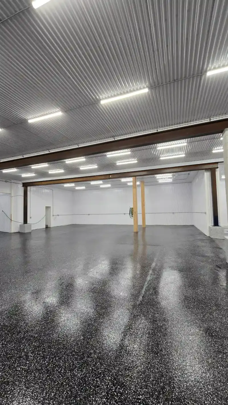 Black flake epoxy floor running through commercial shop bays