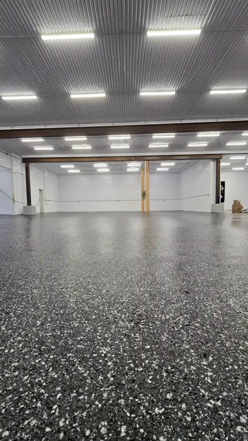 Finished black flake epoxy floor across a warehouse