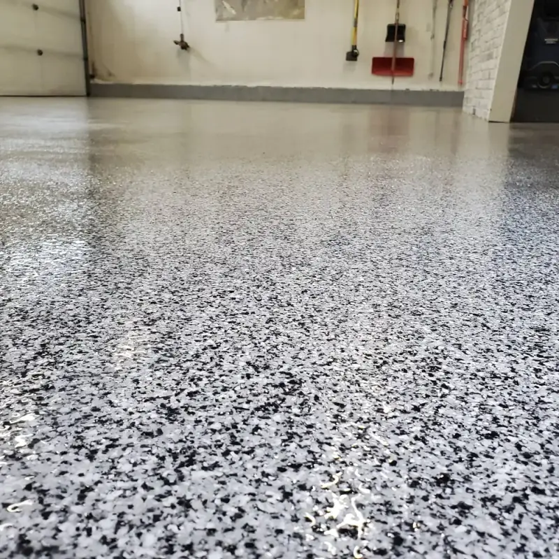 Close view of a glossy black, white and grey flake garage floor