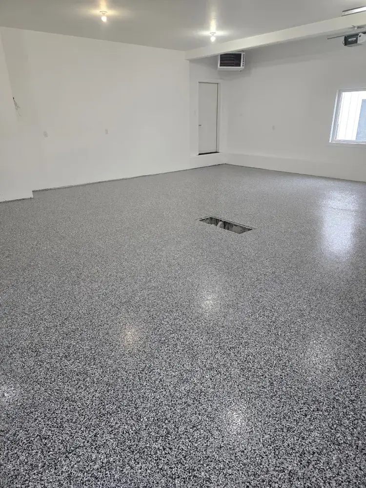 Dark flake epoxy floor in a finished residential garage