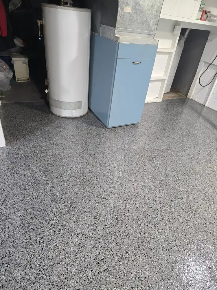 Grey flake epoxy floor in a finished basement laundry area