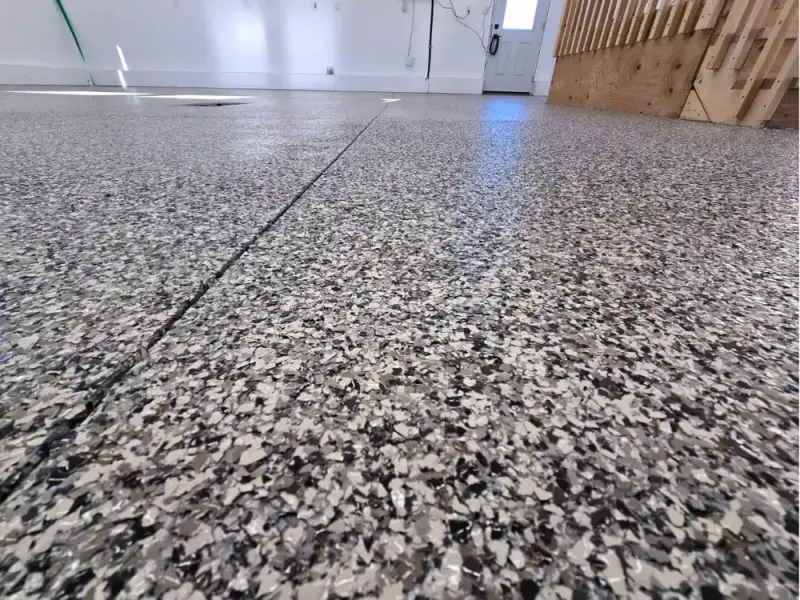 Close view of a grey flake epoxy garage floor
