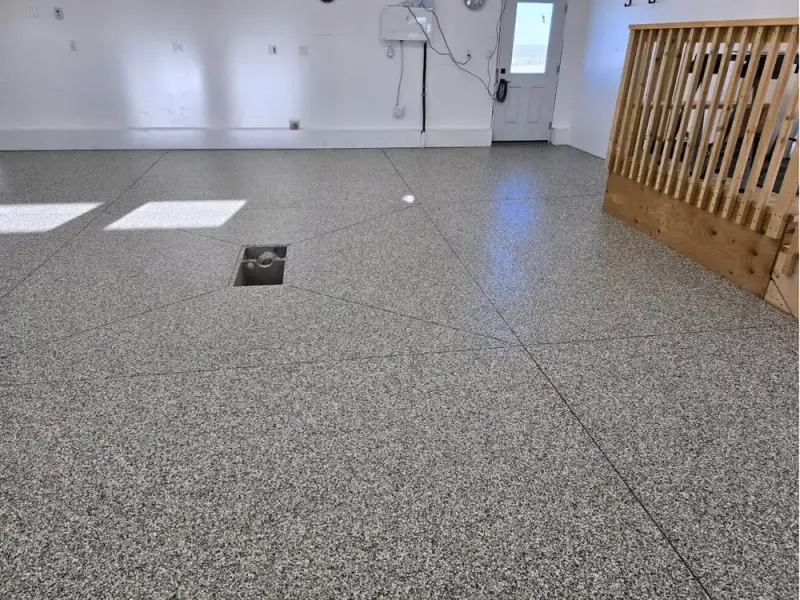 Grey flake epoxy floor in a finished residential garage
