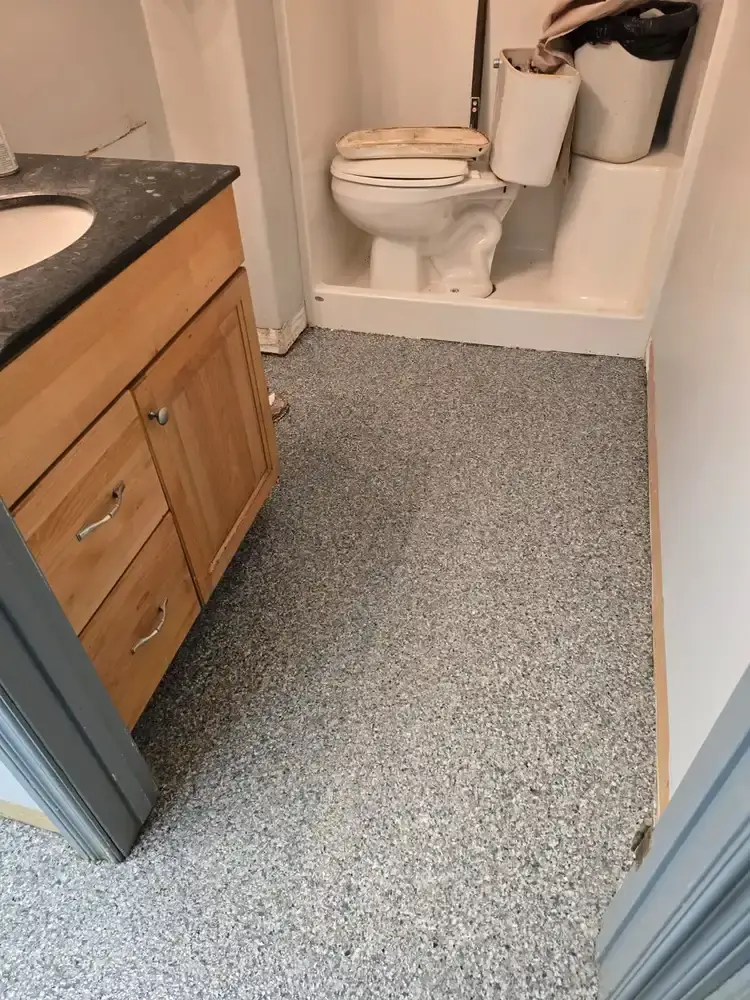 Grey flake epoxy floor in a commercial washroom