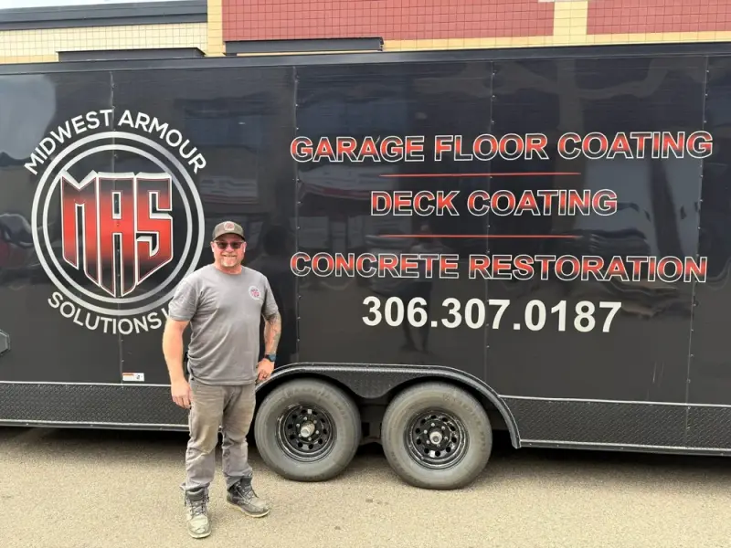 Mike Toupin standing in front of the Midwest Armour Solutions trailer