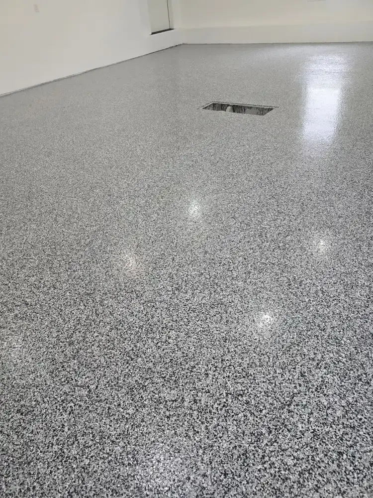 Polished grey epoxy floor in an empty residential garage