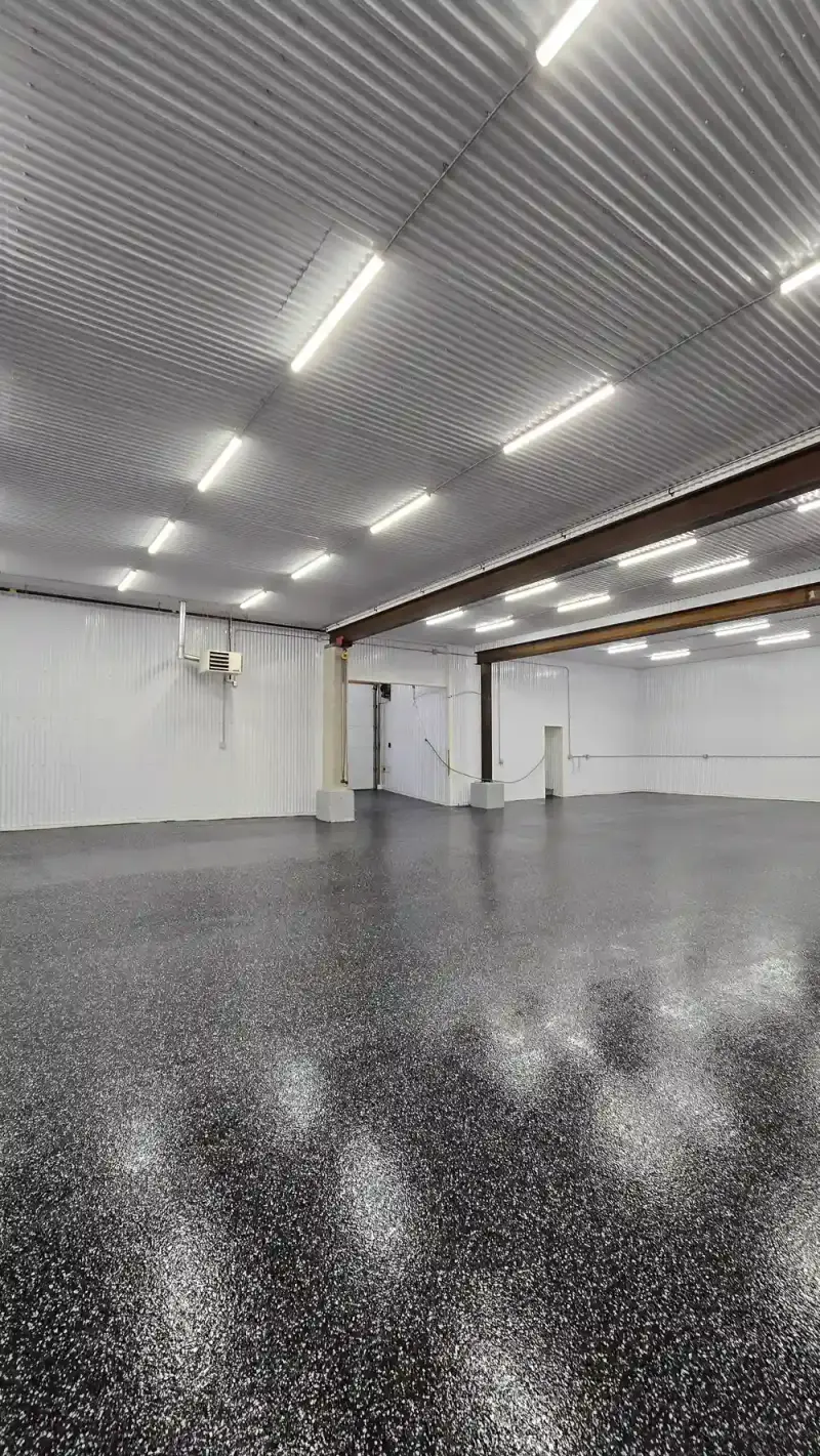 Reflective black flake floor across a commercial shop
