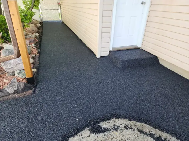 Rubber-paved walkway along the side of a house