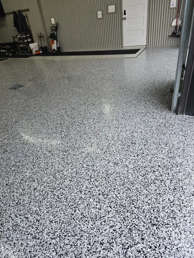 Black and white flake epoxy floor in a finished garage