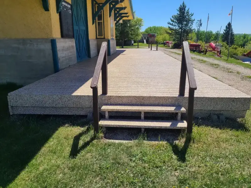 Tan speckled coating across a raised commercial deck