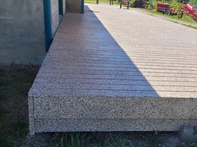 Tan speckled coating on an outdoor walkway and steps